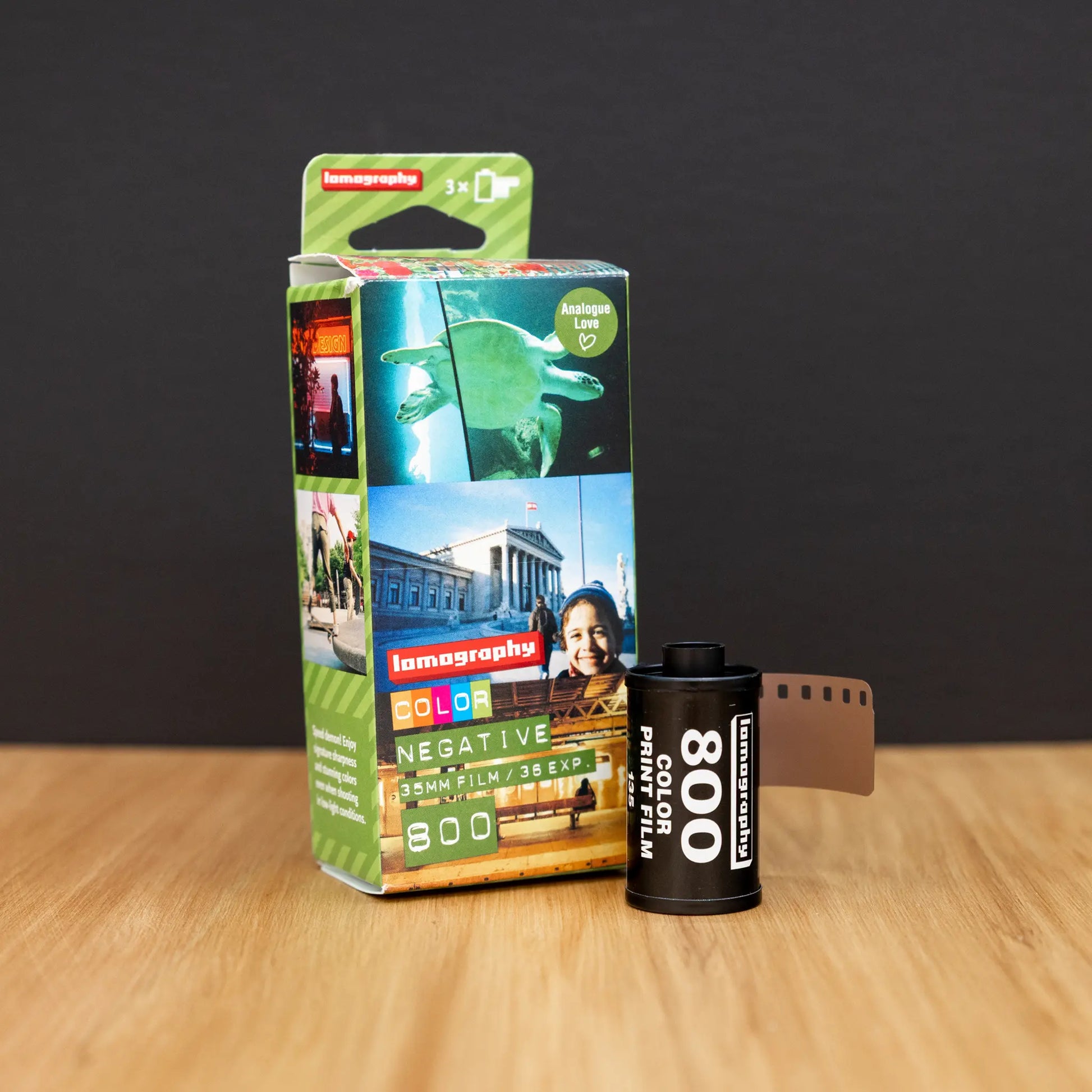 Lomography 800 film with a roll of 35mm film on a wooden surface