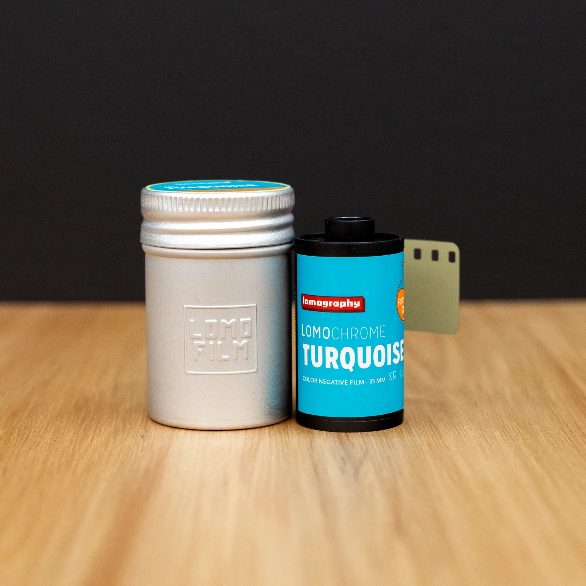 LomoChrome Turquoise film canister with LomoFilm container on a wooden surface