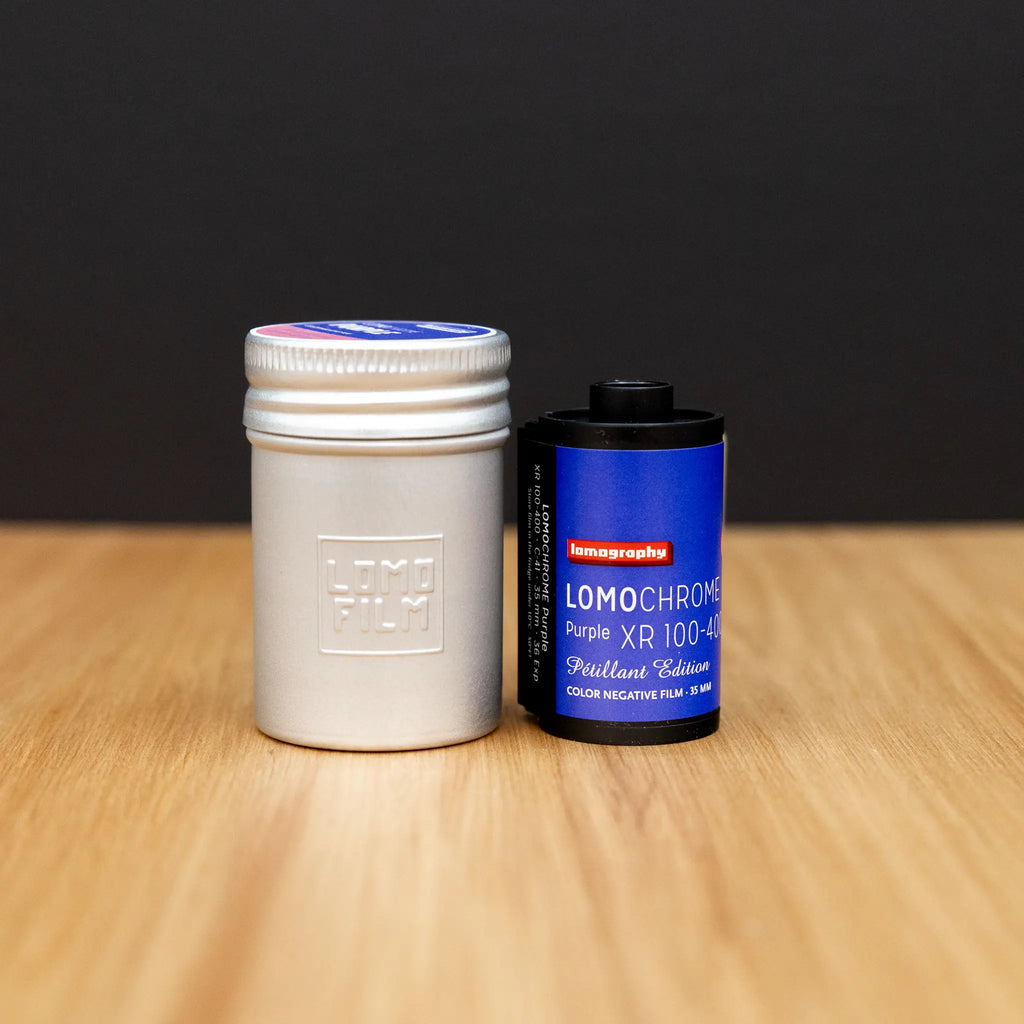 A roll of lomography  Purple film on a wooden surface with a black background