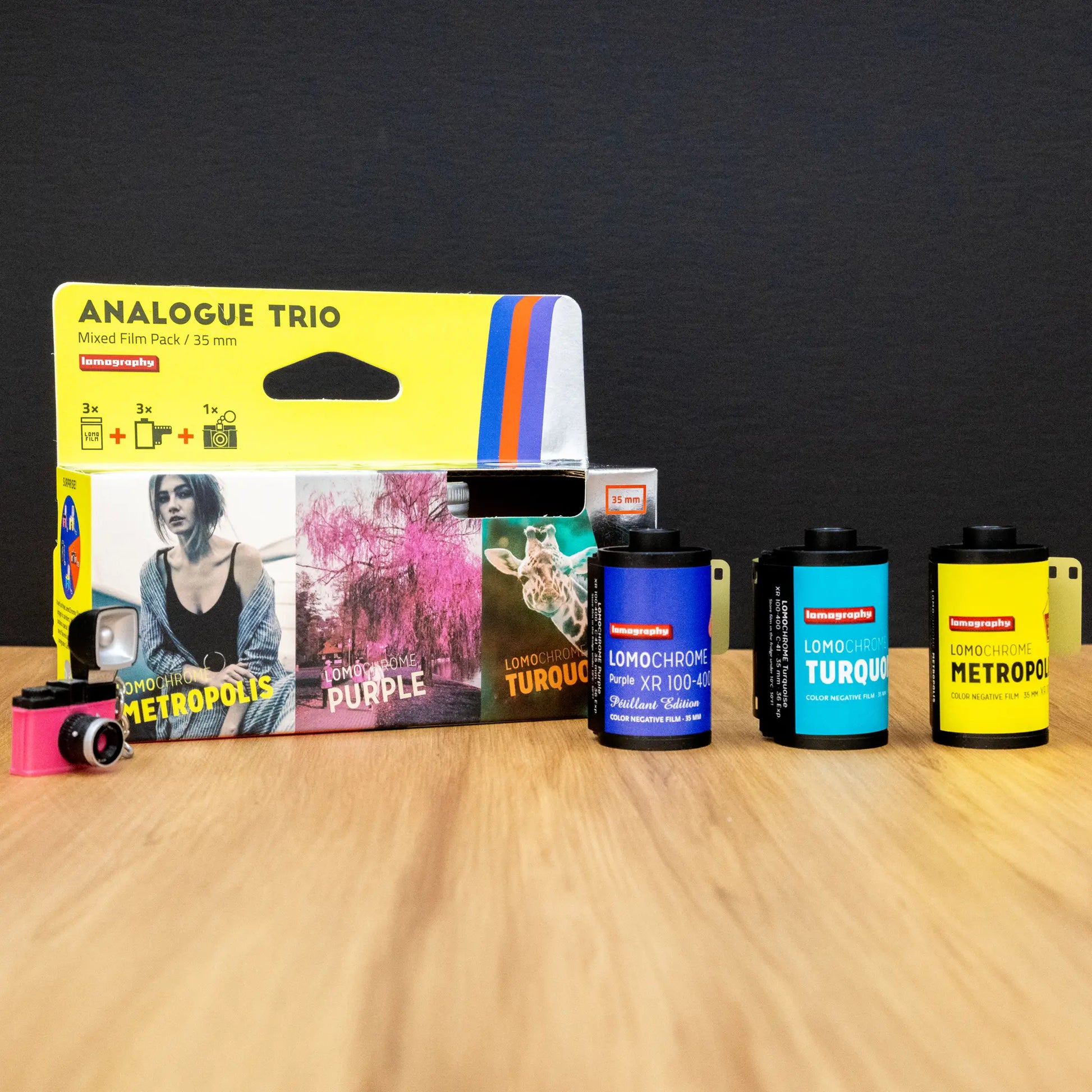 Packaging of Lomography film products on a wooden surface with a dark background