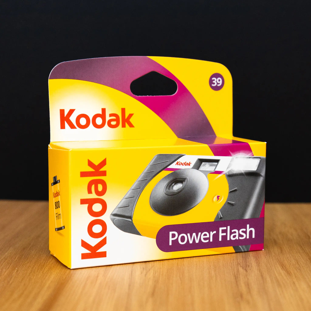 Kodak Power Flash packaging on a wooden surface with a black background