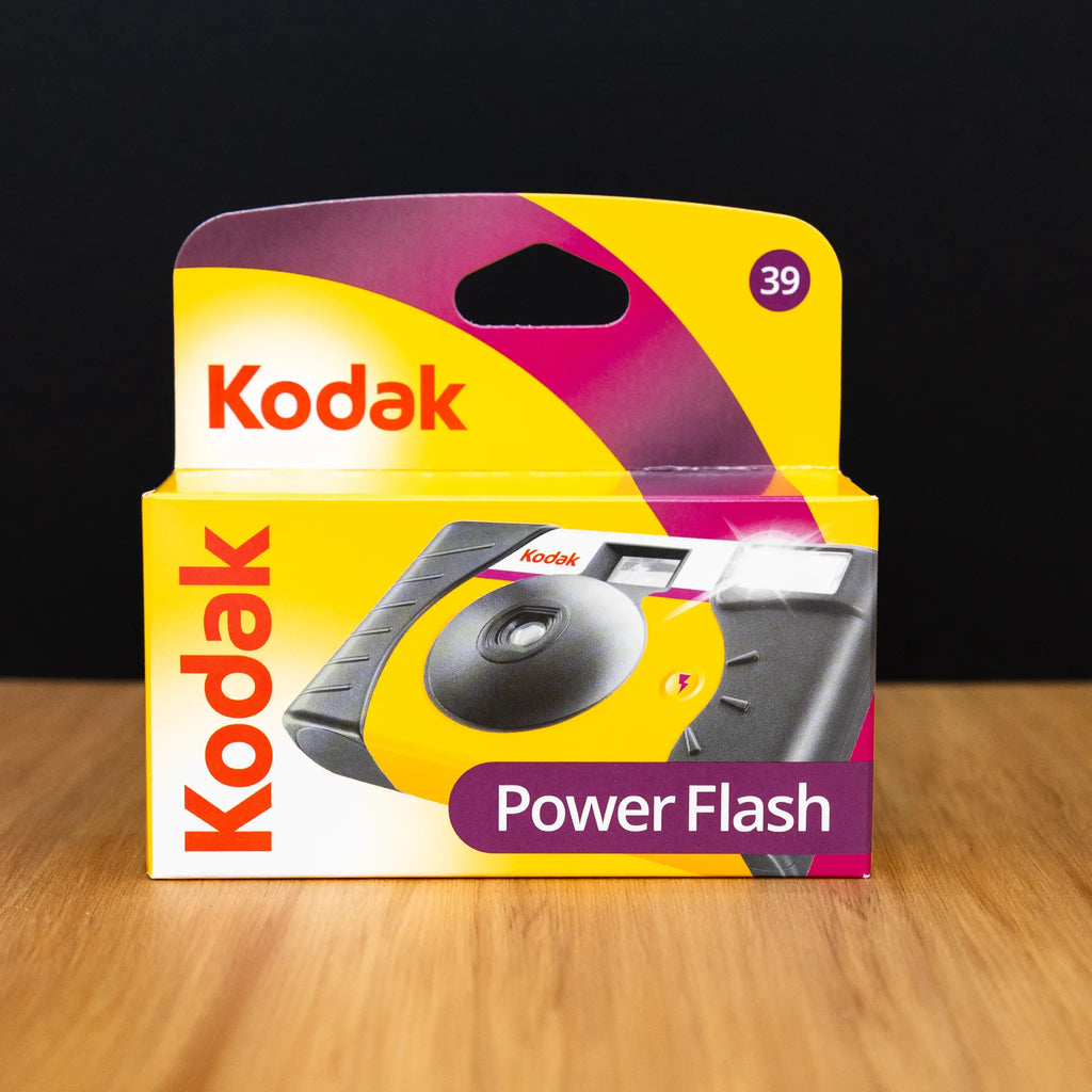 Kodak Power Flash packaging on a wooden surface with a black background